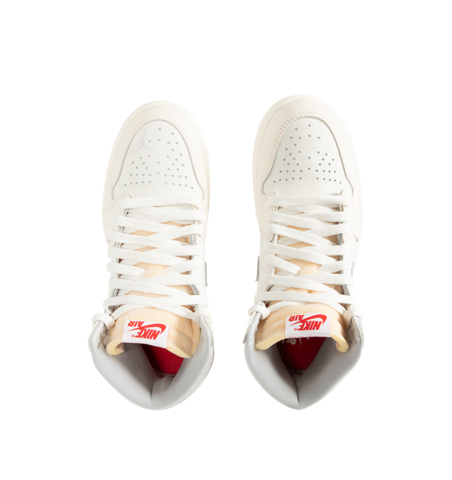 Image 5 of 5 - WHITE - NIKE Air Jordan 1 Retro High OG Sneaker featuring premium leather, elephant print on the Swoosh logo, lace up closure, translucent outsole, exposed foam in the tongue and red contrast stitching on the heel. 