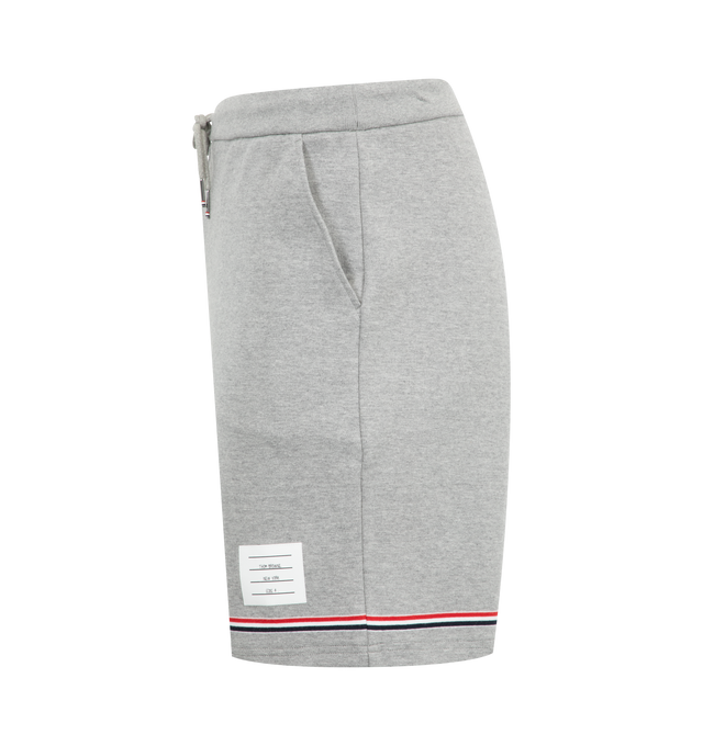 Image 3 of 3 - GREY - Thom Browne Interlocking RWB Stripe Mid Thigh Shorts have a drawstring waistband, side pockets, a signature grosgrain loop tab, and an interlocked RWB stripe. 100% cotton. Made in Japan.  