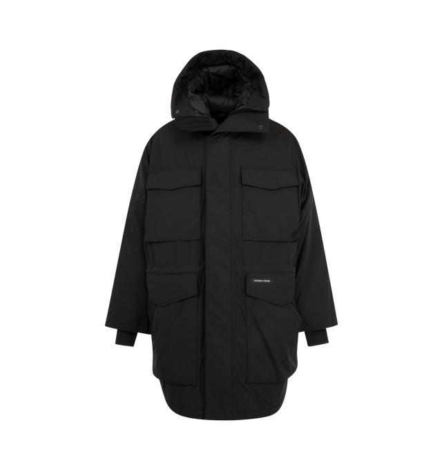 Image 1 of 4 - BLACK - Canada Goose Men's Erie Parka Tonal Disc is crafted from Recycled Organic Arctic Tech and features a heritage-inspired design engineered for extreme cold-weather conditions. Designed with an adjustable hood, fleece chin guard, and an interior drawcord waist, this down-filled parka delivers warmth, protection, and versatility. Functional details include four fleece-lined double-entry pockets, a sleeve pocket, one interior zippered security pocket, two interior drop-in pockets, elbow pa 