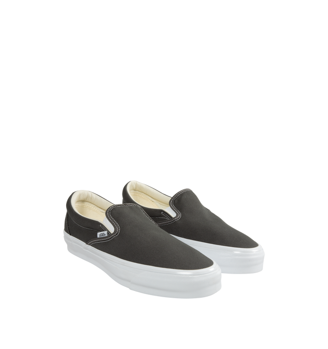 Image 2 of 5 - GREY - Vans slip-on canvas shoes with elastic gores for a flexible fit and logo detailing at quarter, heel, and footbed. Fits true to size. Canvas upper, fabric lining, rubber sole. 