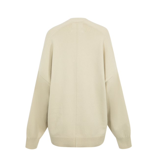 Image 2 of 2 - NEUTRAL - Extreme Cashmere V-Neck Tokio Cardigan Sweater has dropped shoulders, 2 patch pockets, and an extra button on the side to customize the fit. 88% cashmere, 10% nylon, 2% elastane. 