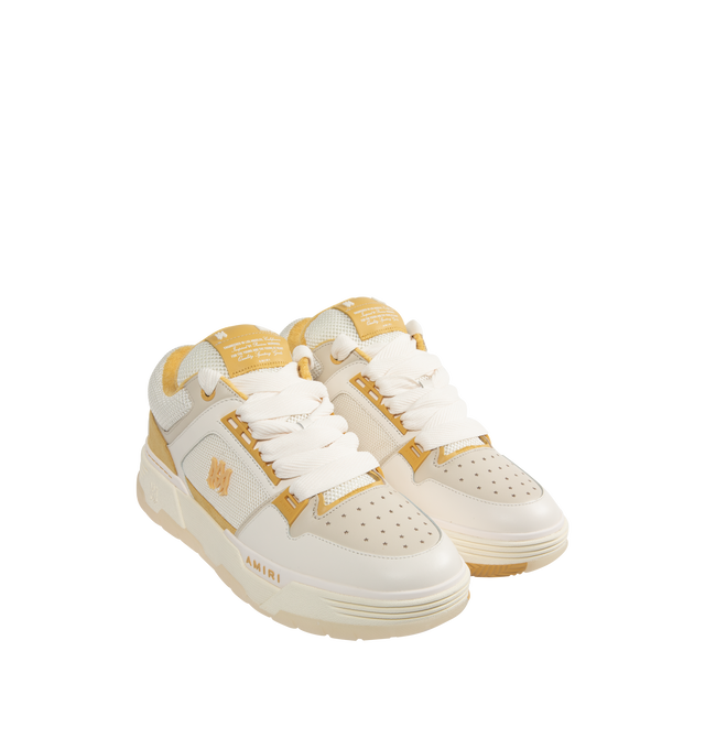 Image 2 of 5 - CHAMPAGNE - Amiri MA-1 Sneakers are a lace-up style with two-tone uppers, a double lace fastening, MA icon hardware, a logo at the back, and exaggerated rubber outsoles. 100% leather uppers. Made in Vietnam.  