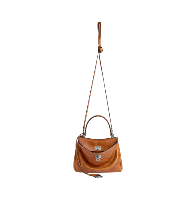 Image 3 of 4 - BROWN - BALENCIAGA Rodeo Handbag Mini featuring vegetal tanned lambskin, one handle hand carry, adjustable and removable crossbody strap, removable cloche cls with two split rings, aged-silver hardware, turn lock closure, wide front pocket, 1 main compartment, 2 flat pockets at back, side snaps, 4 brass feet and nappa lambskin lining. Lambskin. Made in Italy.  