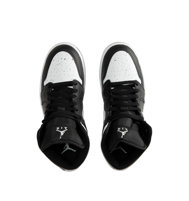 Image 5 of 5 - MULTI - Jordan Men's Air Jordan 1 Mid SE Sneakers feature a black and white upper crafted from genuine leather and textile. The mid-top silhouette is accented with a Wings logo at the collar and a Jumpman logo on the tongue, while an encapsulated Nike Air-Sole unit provides lightweight cushioning. Upper: Genuine Leather and Textile. Sole: Rubber.  