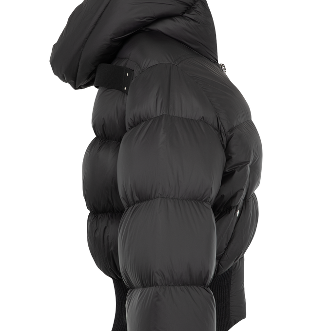 Image 3 of 3 - BLACK - Rick Owens Women's Cinched Hooded Jacket is crafted from lightweight matte nylon and features a waist-length silhouette with a hood and wide ribbed waistband and cuffs. Designed with a center-front zip closure with top snap, snap-closure side pockets, and a signature cotton webbing strap with rivet detailing across the back yoke. Main Material: 100% Polyamide. Rib Knit Trim: 93% Virgin Wool, 5% Nylon, 2% Elastane. Lining: 100% Cupro. Padding: 90% Goose Down, 10% Mallard Feathers. 