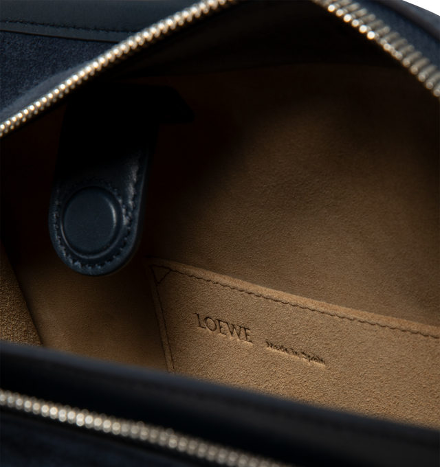 Image 5 of 5 - NAVY - LOEWE Large Amazona 180 Bag in suede featuring a relaxed silhouette anchored by a single toron top handle, designed to be carried open while a concealed closure secures the main compartment, removable shoulder and crossbody straps, zip closure with two leather zip pullers, two compartments, main compartment closed with magnetic closure, internal flat pocket, left side d-ring for customization, suede and nappa lambskin lining, embossed LOEWE and embossed double L branding. Suede/calf. 2 