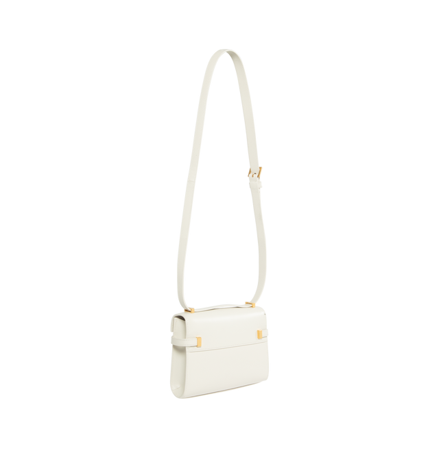 Image 2 of 3 - WHITE - Saint Laurent Mini Manhattan Cross-body box bag with a small flap on top with magnetic clip buckle compression closure, compression tabs on the sides, featuring an adjustable shoulder strap. Calfskin leather with bronze-tone metal hardware. Interior features leather lining, one main compartment with one card slot. Measures  7.4 X 5.5 X 1.5 inches. Made in Italy.  