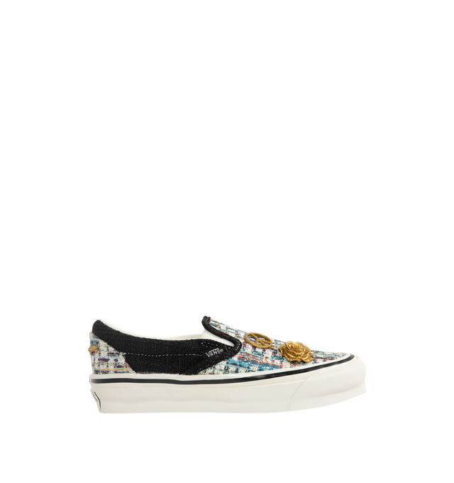 Image 1 of 5 - BLACK - Vans iconic slip-on shoe crafted from midweight canvas adorned with metal pins with rhinestones and crystal studding.  Elevated design featuring higher sidewalls with gloss finish, enhanced cushioning and padded collar for support and all-day comfort. Elastic side panels for easy slip-on and off. Sola Foam ADC (All-Day Comfort) insole for soft and durable cushioning. Signature waffle outsole pattern for reliable grip. 