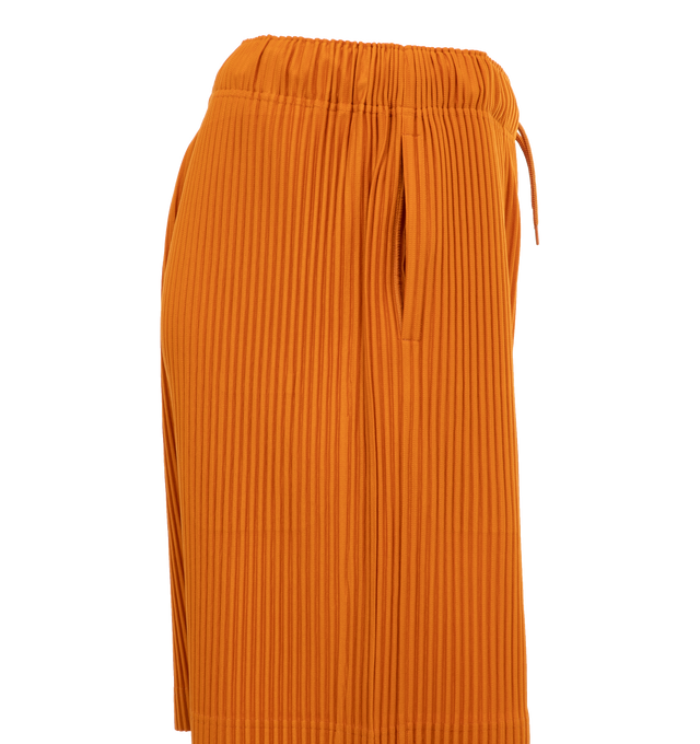 Image 3 of 4 - ORANGE - ISSEY MIYAKE Pants featuring a relaxed, wide leg, two side pockets, and an elastic drawstring waist. 100% polyester. 