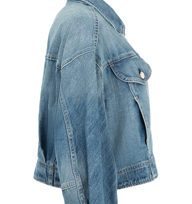 Image 3 of 3 - BLUE - Ruadh Women's Mhor Jacket is handcrafted from rigid regenerative cotton with a subtle cross-hatch texture that softens with wear for enhanced comfort. Designed with a bias-cut sleeve panel, this denim jacket creates an organic, flattering silhouette while maintaining a structured feel. Finished with the brand's signature semi-precious gold-tone hardware. Main Material: 100% Regenerative Cotton. Signature Gold-Tone Hardware. Made in USA. 