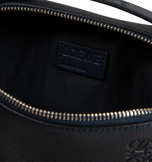 Image 3 of 3 - NAVY - Loewe Men's Mini Camera Crossbody bag in soft grained calfskin. Versatile wearable Mini Camera Crossbody bag with two zip compartments, crossbody or top handle carry, adjustable and detachable LOEWE webbing strap, herringbone cotton canvas lining and embossed Anagram. Height 5.1" x Width 7.1" X Depth 3.3". Made in Spain. 