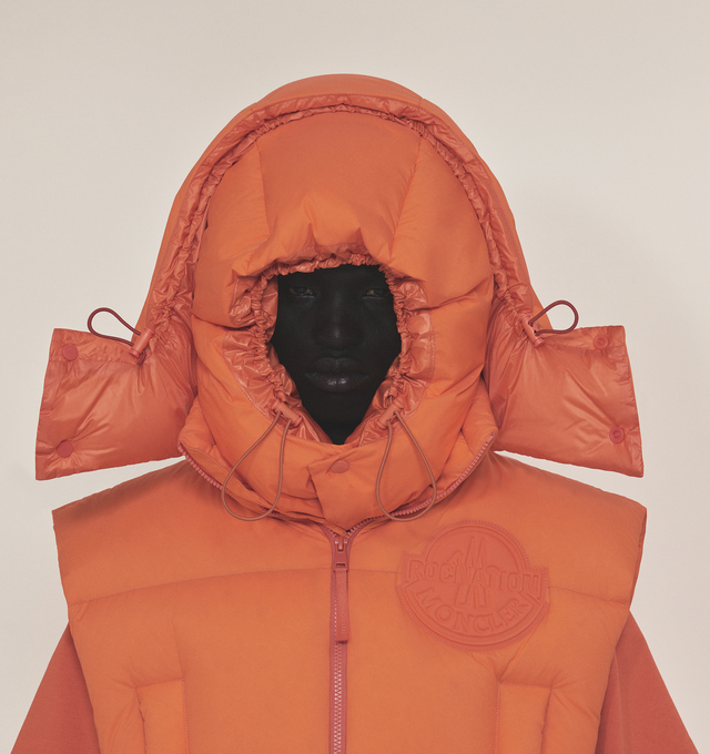 Image 5 of 5 - ORANGE - MONCLER GENIUS MONCLER X ROC NATION BY JAY-Z APUS VEST is a fluorescent-orange hue that brings standout style to this channel-quilted down vest detailed with a tonal patch bearing the logos of both labels, two-way front-zip closure, stand collar; fixed hood, chest welt pockets, front welt pockets and lined, with down fill. 100% nylon. 