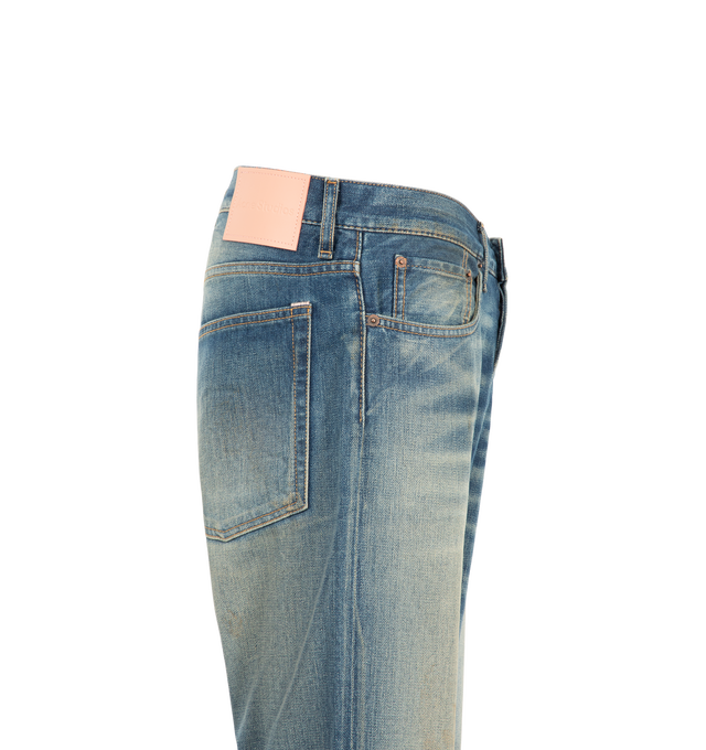 Image 3 of 3 - BLUE - Acne Studios Men's 2010M Streams Jeans are crafted from lightweight indigo-blue broken twill denim and feature a regular-fit silhouette with a low waist and straight leg. Finished with contrasting whiskering and scraping for an authentic worn-in appearance, these jeans are designed with a long length, classic five-pocket construction, and a button fly closure. Main Material: 82% Cotton, 18% Lyocell. Patch: 100% Cow Leather.  