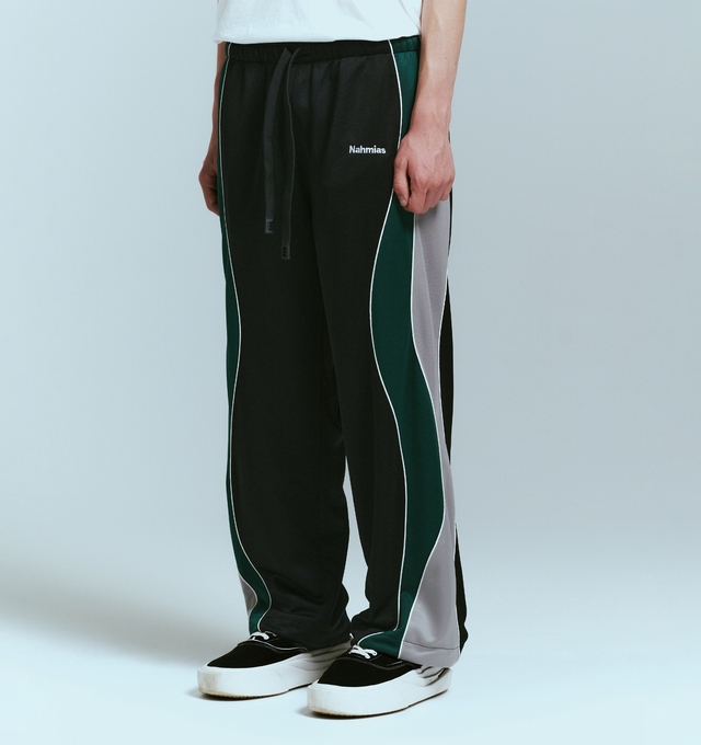 Image 3 of 4 - BLACK - NAHMIAS Ollie Track Pant featuring elastic waist with drawstring closure, 4-pocket styling, embroidered logo, relaxed fit and stripes and piping down leg. 100% polyester.  
