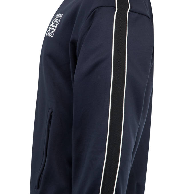 Image 3 of 3 - NAVY - Loewe Men's Tracksuit Jacket in lightweight technical jersey featuring herringbone tape on the sleeves and a mesh lining. Relaxed fit, regular length featuring high neck, rib knit collar, cuffs and hem, zip-front fastening, zipped welt pockets and LOEWE Anagram embroidery placed on the chest. Polyamide/Cotton. Made in Portugal. 
