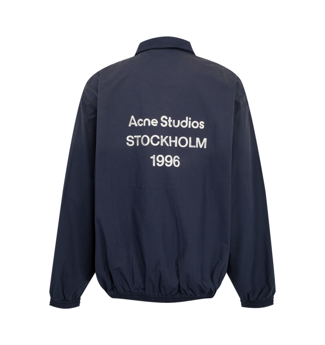 Image 2 of 3 - NAVY - Acne Studios Mens Technical Jacket is crafted from cotton poplin. Features a relaxed fit, high collar, two-way zip closure, side seam zip pockets, elasticized cuffs and hem, mesh lining, and Acne Studios 1996 logo stamp artwork. Main Material: 100% Cotton; Lining: 82% Nylon, 18% Elastane. Made with organically grown cotton and recycled nylon lining. Made in Portugal. 