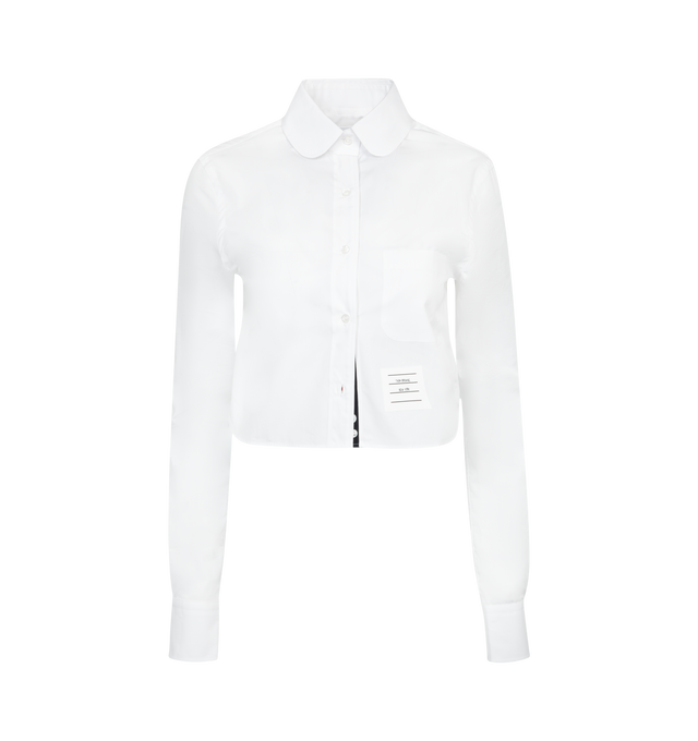 Image 1 of 2 - WHITE - Thom Browne classic cropped round collar poplin shirt with. Featuring front button closure, single chest pocket, meticulous tailoring and definitive Thom Browne emblems throughout: red, white and blue grosgrain placket, nametag applique, pleated back yoke with locker loop and signature striped grosgrain loop tab. 