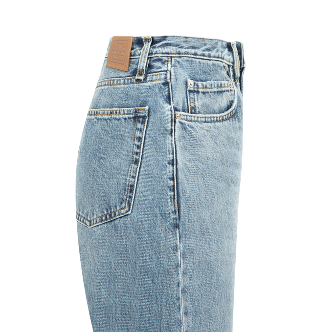 Image 3 of 3 - BLUE - TOTEME Twisted Seam Denim full length featuring relaxed fit, straight-leg, a dropped rise, constructed with directional side seams, button fly, silver-tone hardware, five pockets, belt loops, finished hem and leather patch. 100% organic cotton. 