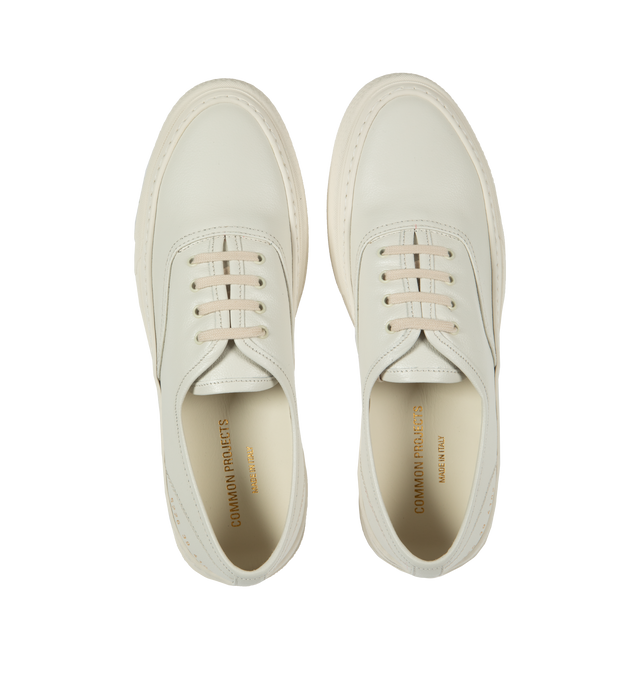 Image 5 of 5 - WHITE - Common Projects Four Hole Lace-Up Sneakers in a low-top design with flat sole, front lace-up fastening, round toe detailed with signature gold number stamp at the heel. Made in Italy. 