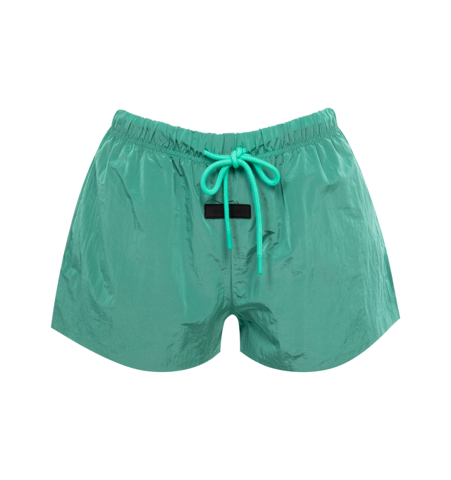 Image 1 of 3 - GREEN - FEAR OF GOD ESSENTIALS Crinkle Nylon Running Shorts featuring a relaxed fit, lightweight crinkle nylon construction, a rubber brand label on the front, side hand pockets, and an adjustable drawstring waistband. 100% nylon.