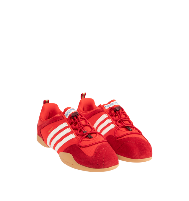 Image 2 of 5 - RED - Adidas Mens Originals x Bad Bunny Ballerina Sneakers are crafted from canvas and suede. Features a low-cut silhouette, lace-up closure with bungee-cord laces, signature 3-Stripes, "Benito" branding, adidas para Bad Bunny detailing, heel pull tab, textile lining, and gum rubber outsole. Upper: Canvas and Suede; Lining: Textile; Outsole: Rubber. Made in Vietnam. 