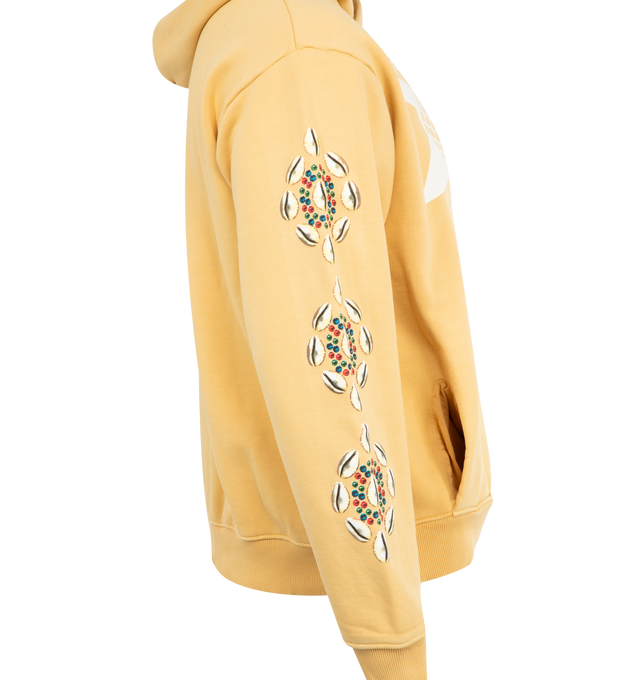 Image 3 of 3 - YELLOW - BARRIERS Cowrie Shell Hoodie featuring 500 GSM french terry, hidden pocket, garment dyed, front graphic with cracked distress print and cowrie sleeves in puff print for 3D effect. 100% cotton.  