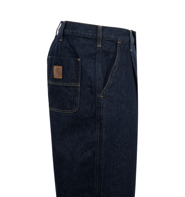 Image 3 of 3 - BLUE - Carhartt WIP Jace Pants are a 4-pocket style with a button fly, front pleats, contrast stitching, a faux leather logo patch on the back pocket, and a loose fit. 100% cotton. Made in Tunisia.  