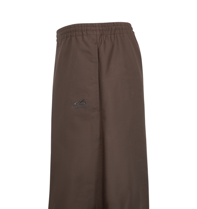 Image 3 of 3 - BROWN - Balenciaga Women's Balloon Tracksuit Pant is crafted from nylon and features the brand's signature balloon silhouette with an exaggerated, voluminous shape. Designed with a relaxed fit and sportswear-inspired construction, these statement track pants combine technical fabrication with Balenciaga's avant-garde proportions for a modern, oversized look. Main Material: Nylon. Made in Italy. 