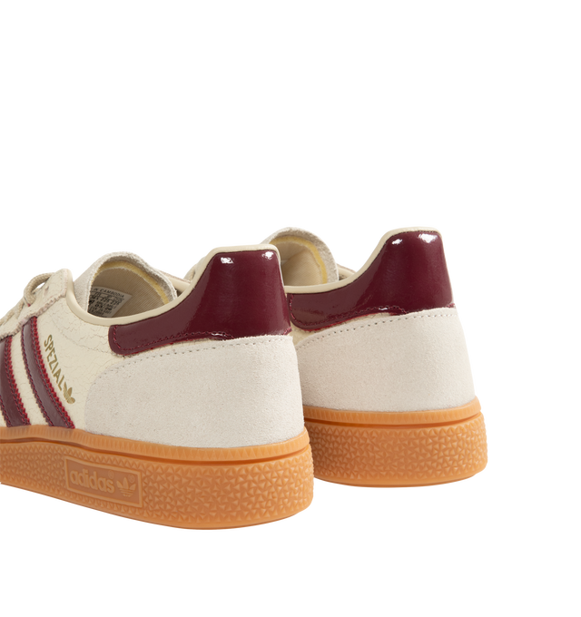 Image 3 of 5 - NEUTRAL - Adidas Men's Handball Spezial Sneakers feature a textured mix of cracked leather, suede overlays, and patent leather 3-Stripes. Designed in a regular fit with a secure lace-up closure, these designer sneakers feature signature Spezial detailing at the quarter and tongue and a soft gum rubber outsole. Upper: Leather. Lining and Insole: Textile and Other Materials. Outsole: Other Materials.  