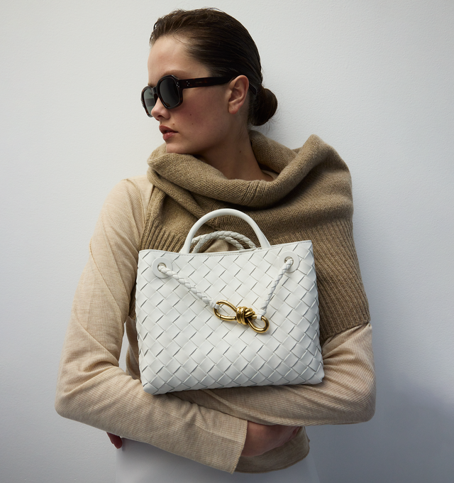 WHITE - BOTTEGA VENETA Small Andiamo featuring leather top handle, sliding cross-body strap, compartmented interior with one zippered pocket, two open pockets and magnetic closure. 7.9" x 9.8" x 3.9". 100% lambskin. Made in Italy.