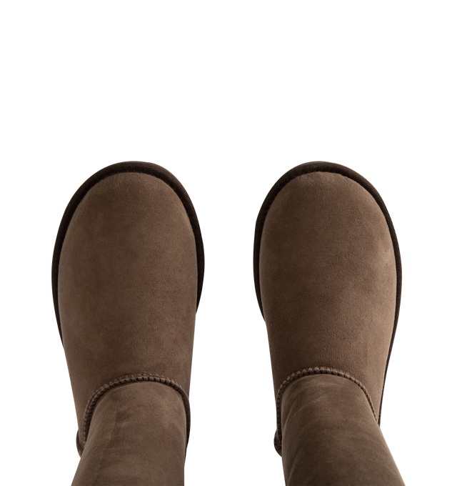Image 4 of 4 - BROWN - Ugg Women's Classic Ultra Tall Boot is a sky-high version of the iconic style. Featuring a 15-inch shaft height, plush sheepskin lining, and an ultra-lightweight rubber outsole for comfort. Main Material: 17mm Twinface Sheepskin. Lining: 17mm Sheepskin. Insole: 17mm Sheepskin. Sole: Sugarcane EVA. Details: Overlock Stitch Seams.  