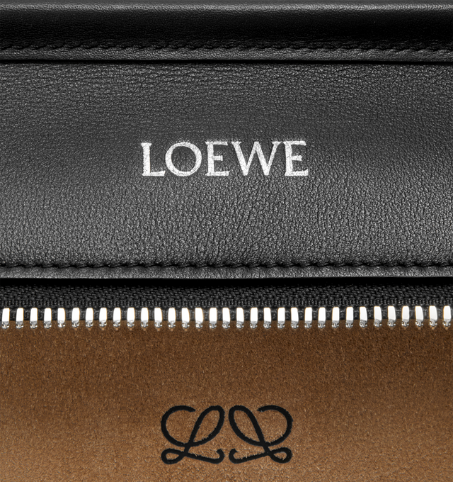 Image 13 of 16 - BLACK - Loewe Amazona 180 large bag takes on a relaxed silhouette anchored by a single toron top handle. It is designed to be carried open, while a concealed closure secures the main compartment. Removable shoulder and crossbody straps make it highly versatile. This large version is crafted in soft calfskin. Three carry options: short handle, removable shoulder strap and crossbody. Features zip closure with two leather zip pullers, two compartments, main compartment closed with magnetic clo 