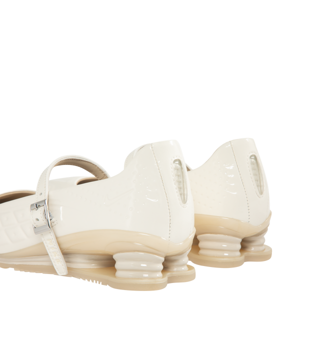 Image 3 of 5 - NEUTRAL - Nike Womens Shox Z Calistra Sneakers feature a molded synthetic leather upper. Designed with an adjustable midfoot strap, Nike Shox Z cushioning pillars, signature Nike and Shox branding, and durable rubber outsole. Upper: Synthetic Leather; Cushioning: Nike Shox Z; Outsole: Rubber. Imported 