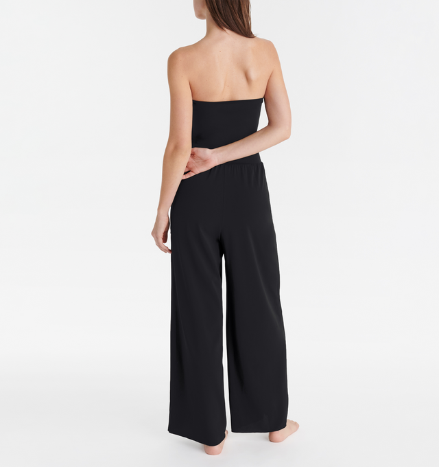 Image 4 of 5 - BLACK - ERES Dao High-Waisted Trousers featuring wide legs and side pockets with tone on tone stitching. Offers versatile styling to wear as a bustier jumpsuit or pants.  Main: 94% Polyamid, 6% Spandex. Second: 84% Polyamid, 16% Spandex. Made in France. 
