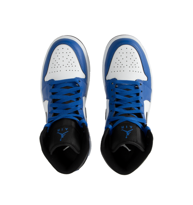 Image 5 of 5 - BLUE - AIR JORDAN 1 MID basketball shoe in white, royal blue and black leather upper featuring an angled profile, toe box perforations, mesh tongues and lining, encapsulated Air cushioning underfoot, and distinctive Jordan detailing. Air-Sole cushioning provides lightweight, responsive comfort.  Leather and textile upper/synthetic lining/rubber sole. 