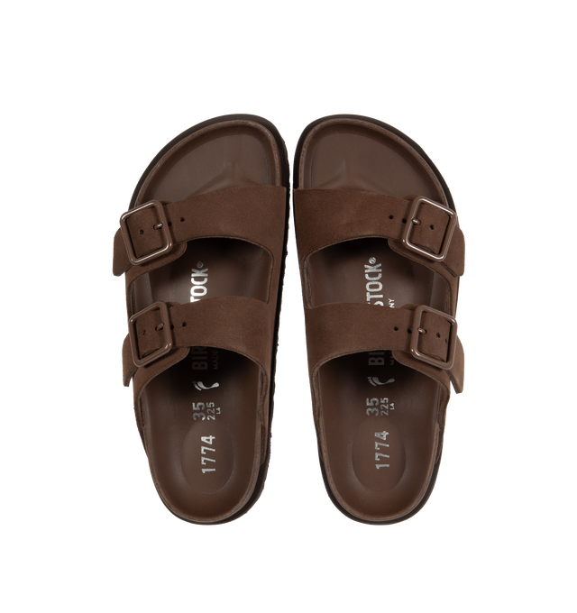 Image 4 of 4 - BROWN - Birkenstock's Arizona sandals in a narrow width. The iconic Arizona sillhouette is  updated in suede featuring adjustable straps with buckle closures, logo details, shaped insole, and EVA outsole. Upper: Luxurious fine flesh out suede, a full grain leather that has been flipped to use the fuzzy side. Footbed: Anatomical shaped BIRKENSTOCK cork-latex footbed, covered with premium, color-matching smooth nappa leather. Sole: EVA outsole with a 3mm EVA welt updates the standard die-cut ou 