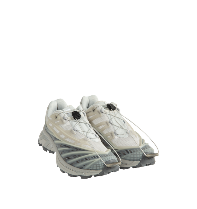 Image 2 of 5 - GREY - Salomon Unisex XT-EVO Sneakers are built with a synthetic and textile upper and are made to be a performance-driven combining stability and cushioning for lasting comfort. Additional details include Quicklace one-pull lacing, endoFit internal sleeve construction, sensiFIT support, seamless construction, and a lace pocket for streamlined wear. A molded OrthoLite sockliner and Mud ContaGRIP rubber outsole enhance cushioning, durability, and traction across varied terrain. Upper: Syntheti 