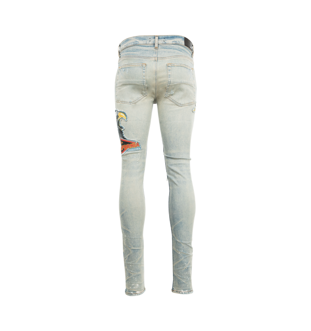 Image 2 of 3 - BLUE - AMIRI MA Cement Thrasher Skinny Jeans featuring stretch denim, belt loops, five-pocket styling, button-fly, hand-distressed detailing at front, patches at leg, leather logo patch at back waistband and logo-engraved silver-tone hardware. 92% cotton, 6% elastomultiester, 2% elastane. Made in United States. 