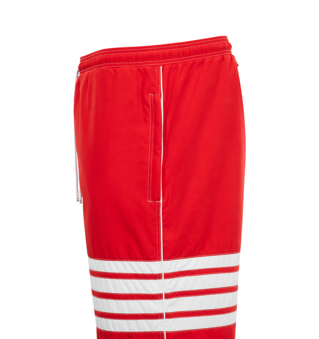 Image 3 of 3 - RED - THOM BROWNE Striped Drawstring Sweatpants featuring signature four bar striping, a drawstring waistband, elastic cuffs and side slip pockets. 100% polyester. Made in Italy. 