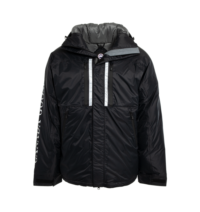 Image 1 of 3 - BLACK - CANADA GOOSE Skreslet Parka featuring 2 Napoleon chest pockets and 2 front pockets, both with water-repellent zipper closures, extra-long sleeves for coverage and mobility, fleece-lined chin guard, fully seam sealed for wind and wet weather protection, interior Pocket: 1 large inner lower mesh pocket designed to hold a water bottle, oversized down hood is adjustable and has a shaping wire for added protection and wide sleeve cuffs with Velcro closure for ease of use and venting. 100%  