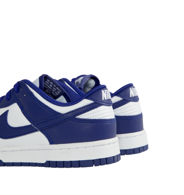 Image 3 of 5 - PURPLE - Nike Dunk Low Sneakers with white and concord purple color-blocking,  a padded, low-cut collar, leather upper with a slight sheen and durability, foam midsole offering lightweight, responsive cushioning. Perforations on the toe add breathability. Rubber sole with classic hoops pivot circle provides durability and traction.  