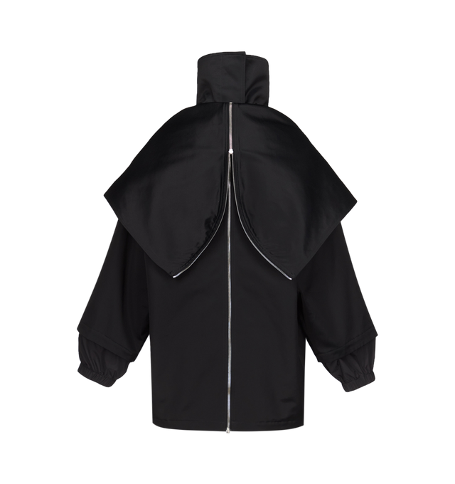 Image 2 of 3 - BLACK - Azzedine Alaa Womens Layered Parka is crafted from structured cotton canvas. Features a high neck, raglan sleeves, concealed placket, side seam pockets, back yoke, zipped hood, and back zipper that reveals a second layer underneath. Designed with a rounded shape and layered construction that can be worn as a traditional hooded jacket or fully opened and draped as a cape. Main Material: 88% Cotton; 32% Viscose, Secondary Material: 74% Polyamide, 26% Silk; Padding: 100% Polyester; Pocke 