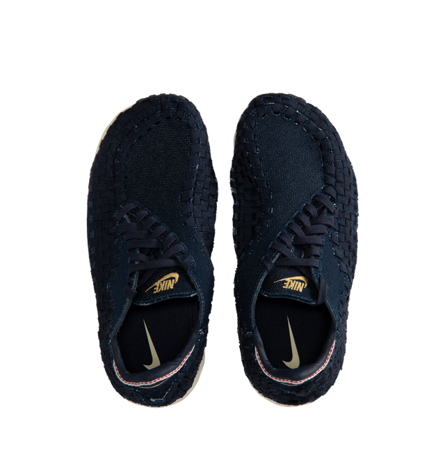 Image 5 of 5 - NAVY - NIKE Air Footscape Woven Sneakers featuring a blue denim colored textile and soft suede upper, asymmetrical woven details, lateral lacing, foam midsole, Nike Air cushioned heel and rubber outsole. 