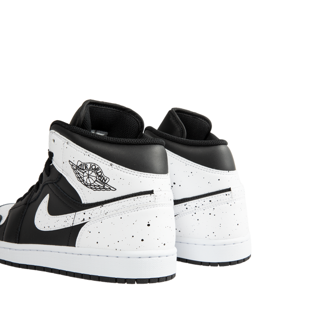 Image 3 of 5 - MULTI - Jordan Men's Air Jordan 1 Mid SE Sneakers feature a black and white upper crafted from genuine leather and textile. The mid-top silhouette is accented with a Wings logo at the collar and a Jumpman logo on the tongue, while an encapsulated Nike Air-Sole unit provides lightweight cushioning. Upper: Genuine Leather and Textile. Sole: Rubber.  