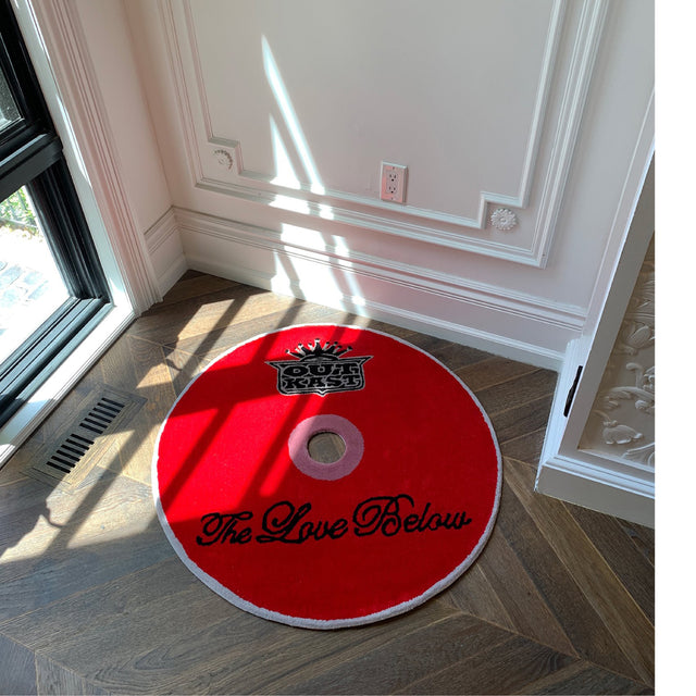 Image 3 of 4 - RED - Curves at Home The Love Below CD Rug. The rug collection highlights a collection of iconic albums. Handmade and hard wearing, it can be displayed as a floor rug or a wall hanging. Hand tufted acrylic with dye-cut center, cotton non-slip backing and binded edges . W 35" x L 35" x D 0.78". *These items are handmade, each rug may come with a slight variation.* 