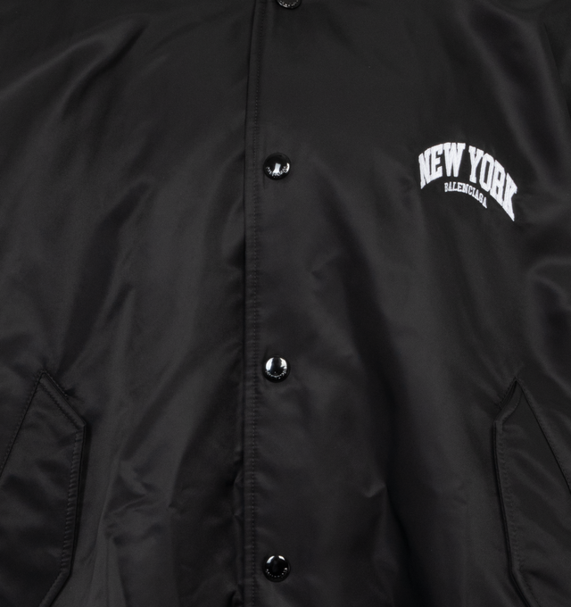 BLACK - BALENCIAGA NY Varsity Jacket featuring light nylon, large fit, snap closure, 2 snap flap pockets at front, ribbed trims and New York with logo embroidered at chest and back. 100% polyamide. Made in Italy.