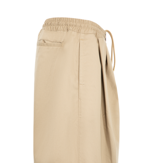 Image 3 of 3 - NEUTRAL - Willy Chavarria Orale Elasticated Short is crafted from a polyester-cotton blend and features a relaxed, voluminous silhouette with an elasticated waistband for everyday comfort. Designed with the brand's signature oversized proportions and clean utility-inspired styling. Main Material: 65% Polyester, 35% Cotton. Lining: 100% Cotton. Made in USA. 