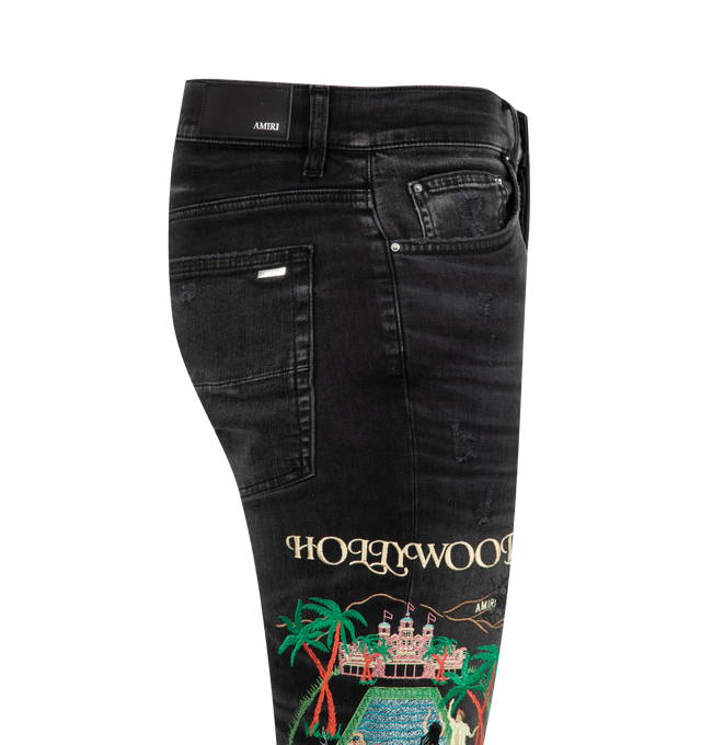 Image 3 of 3 - BLACK - AMIRI MA Cement Thrasher Skinny Jeans featuring stretch denim, fading, distressing and whiskering throughout, belt loops, five-pocket styling, button fly, embroidered graphic at outseams and skinny fit. 92% cotton, 6% elastomultiester, 2% elastane. Made in United States. 