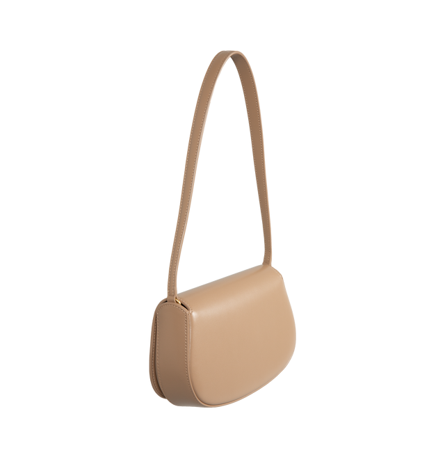 Image 2 of 3 - BROWN - Saint Laurent Mini Voltaire half-moon shoulder bag in calfskin with gently polished finish. Features a flap with magnetic Cassandre hinge closure and one flat interior pocket. Calfskin leather with leather lining and bronze-tone hardware. Made in Italy. Measures 8.3" X 4.3" X 1.8" with 9.4" strap drop.  