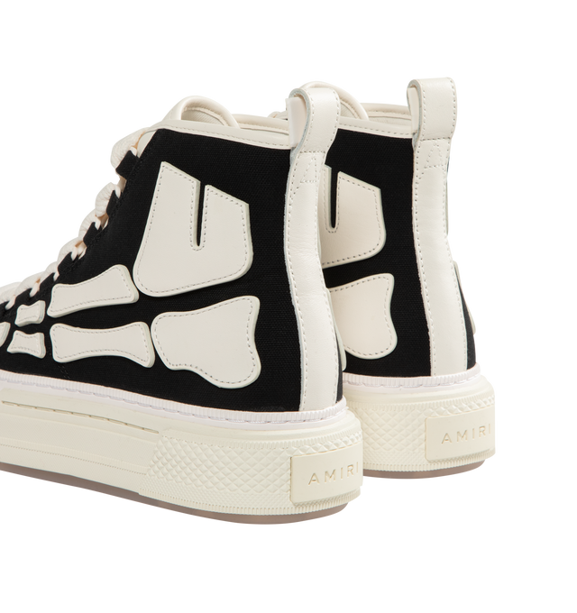 Image 3 of 5 - BLACK - AMIRI Skel Court Hi Sneakers featuring high-top cotton canvas and buffed leather sneakers, rubber cap toe, lace-up closure, logo embossed at tongue, pull-loop at heel collar, graphic appliqus at sides, logo embossed at outer midsole and treaded rubber sole. Upper: textile, leather. Sole: rubber. 